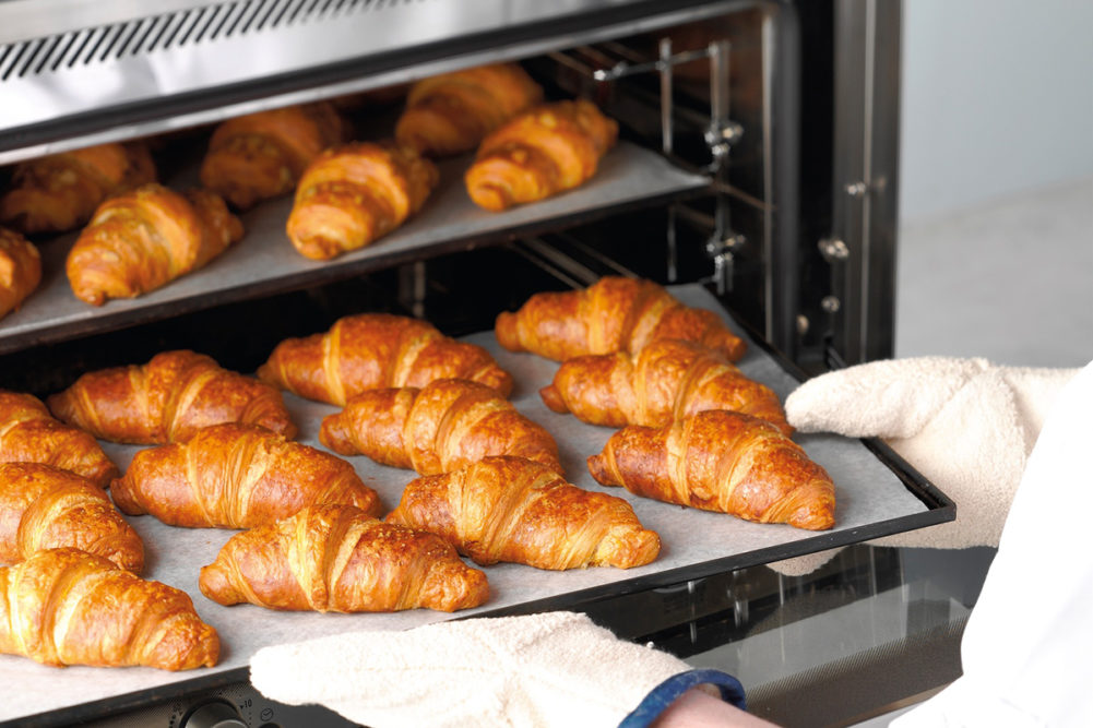 croissants on a baking sheet pan coming out of an oven