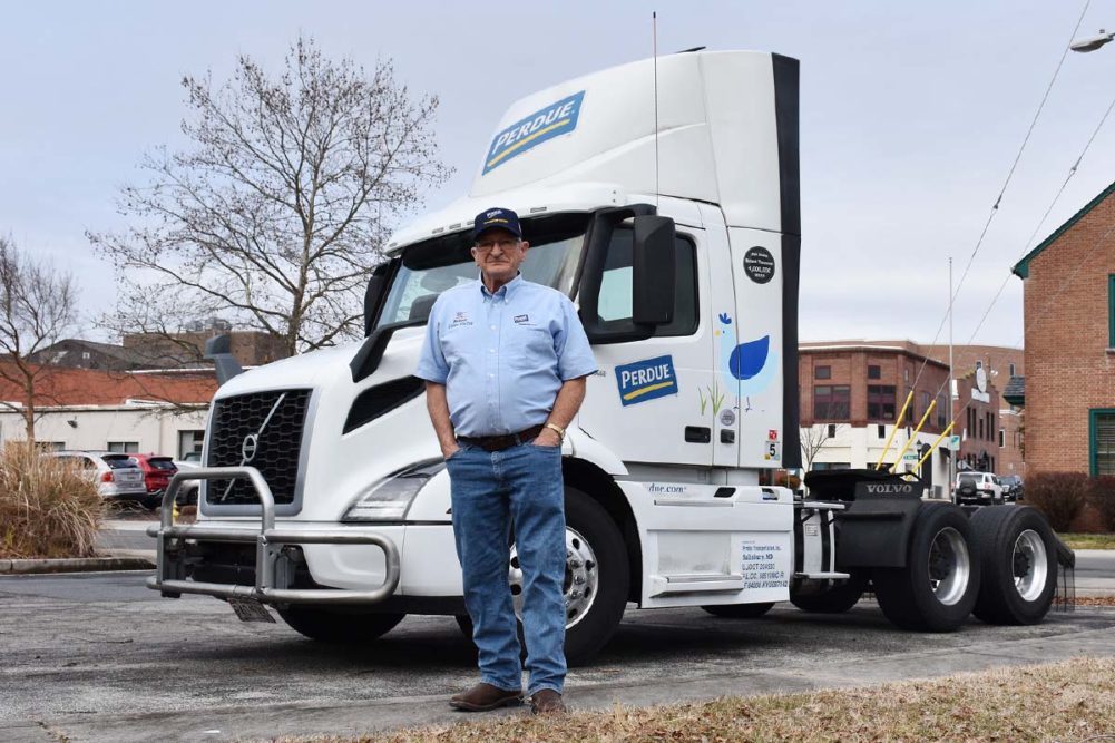 Robert Timmons in front of a Perdue Farms delivery truck