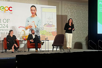 three people presenting on stage