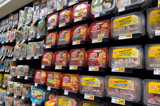 Angled view of sandwich meat for sale inside a QFC grocery store.